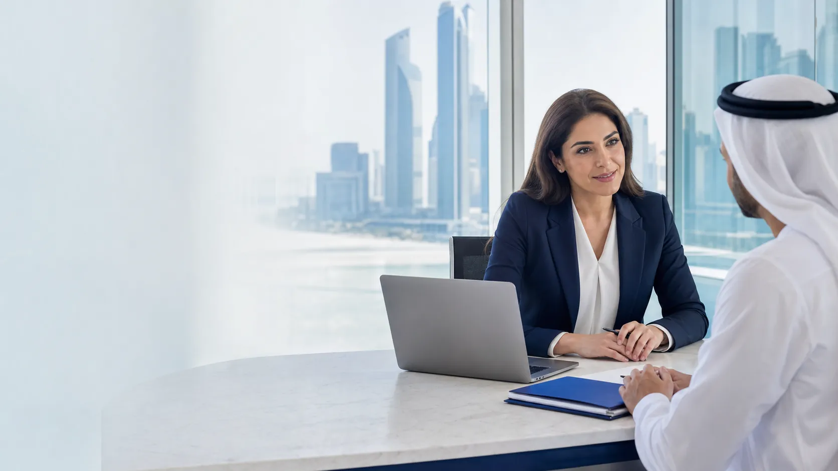 Integrity Limited advisor speaking with a client in a modern UAE office